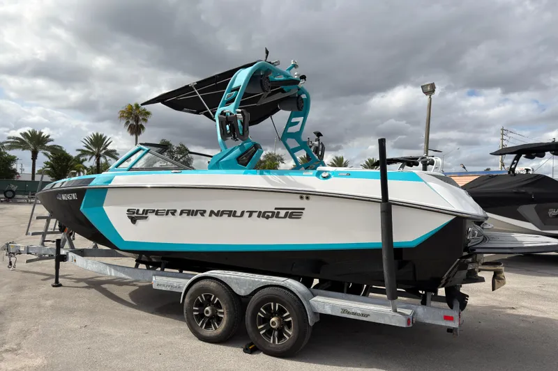Slide: The Image of 2019 Nautique Super Air Nautique G23 Coastal Edition boat on trailer, cloudy sky background. - 9