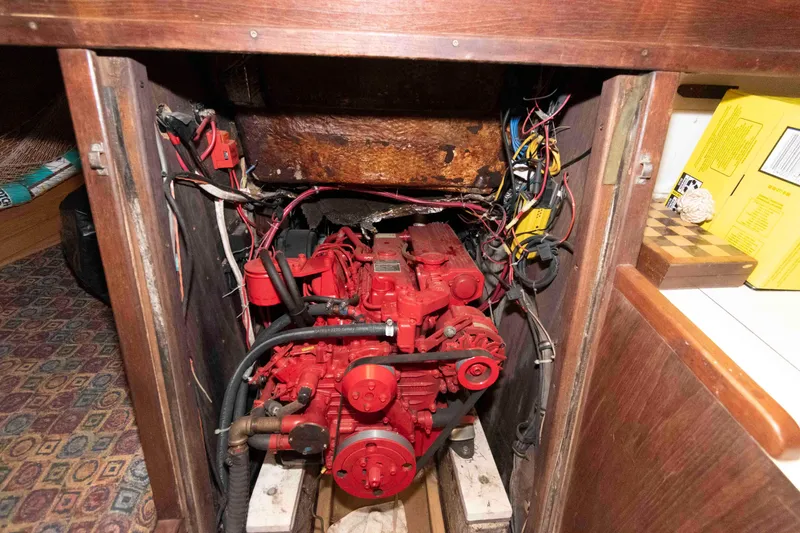 Slide: The Image of Engine compartment of a 1985 Morgan 384 sailboat with red engine and wiring. - 11