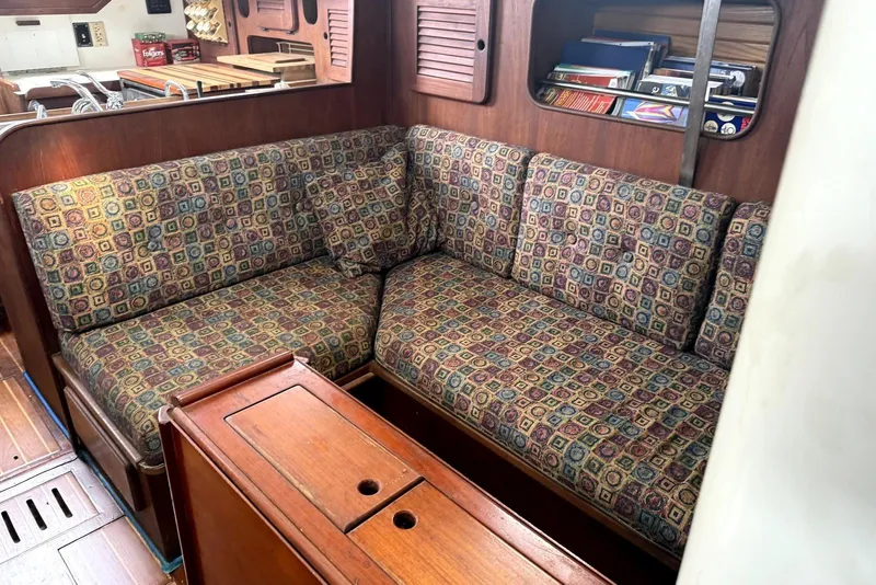 Slide: The Image of Interior of 1985 Morgan 384 sailboat with cozy seating and wooden finishes. - 2