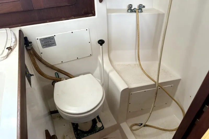 Slide: The Image of Interior of a 1985 Morgan 384 sailboat with patterned seating and wooden finishes. - 3