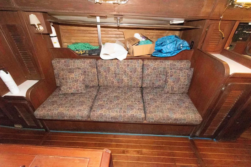 Slide: The Image of Interior of 1985 Morgan 384 sailboat with patterned sofa and wooden cabinetry. - 5