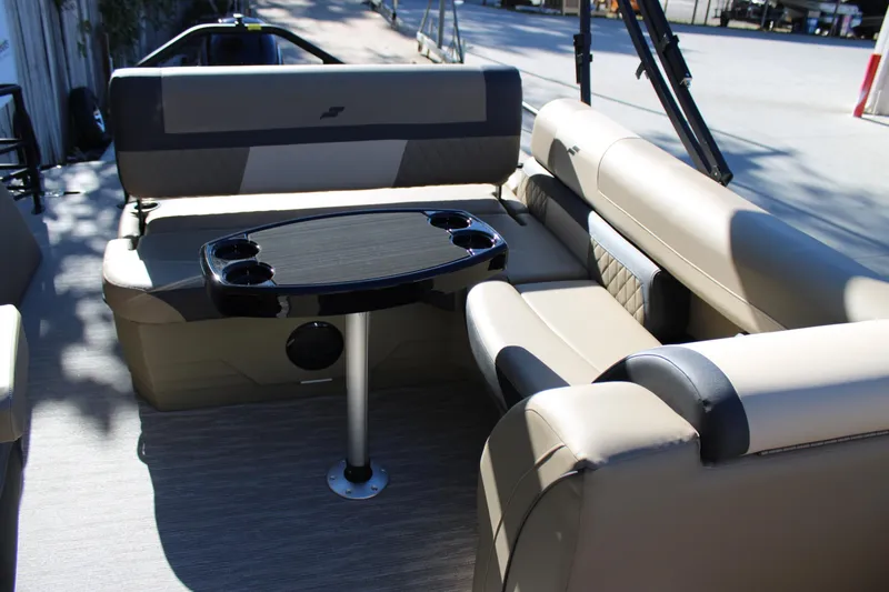 Slide: The Image of Luxurious seating area on 2026 Starcraft EXS 3 Q boat with table and cup holders. - 11