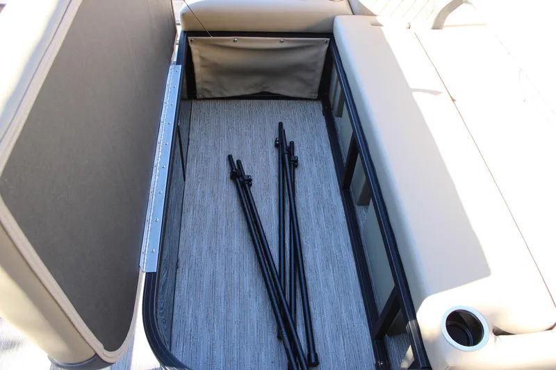 Slide: The Image of 2026 Starcraft EXS 3 Q boat interior with beige seating and storage area. - 12