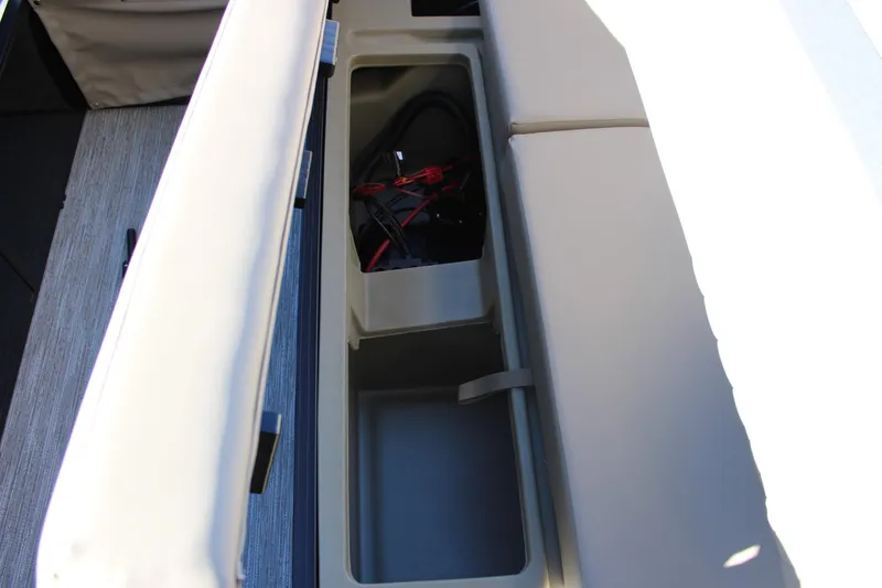 Slide: The Image of 2026 Starcraft EXS 3 Q boat storage compartment with battery and wiring. - 13