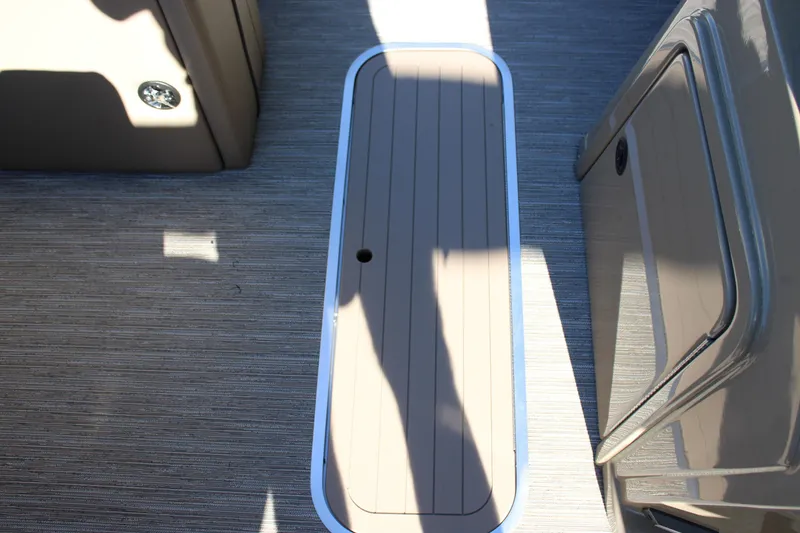 Slide: The Image of 2026 Starcraft EXS 3 Q boat interior with sleek flooring and storage compartment. - 22