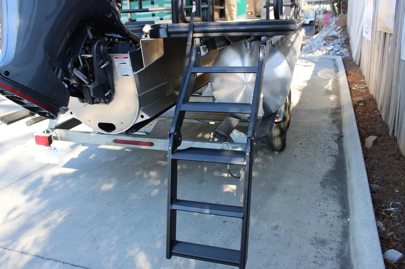 Slide: The Image of Rear view of 2026 Starcraft EXS 3 Q boat with ladder and motor on trailer. - 6