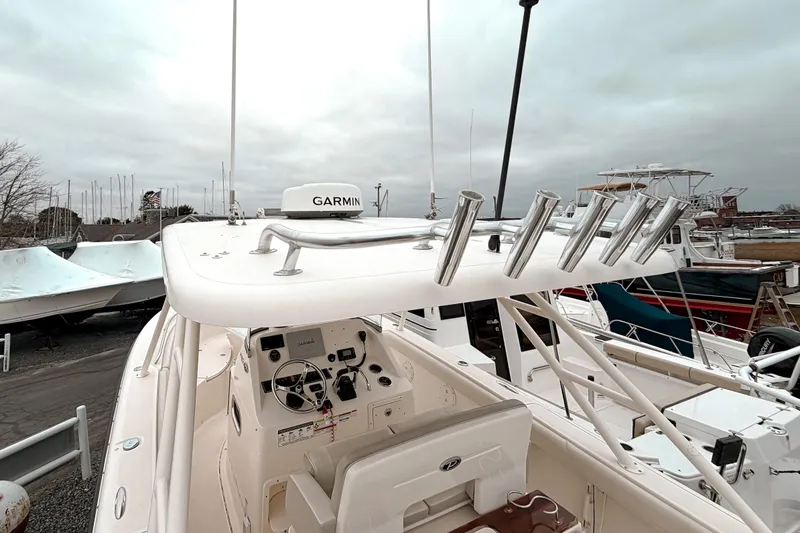 Slide: The Image of 2014 Pursuit S 280 Sport boat with Garmin equipment, docked under cloudy skies. - 13