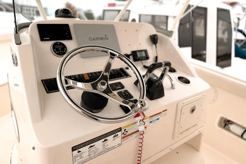 Slide: The Image of Control panel of 2014 Pursuit S 280 Sport boat with Garmin navigation system. - 14