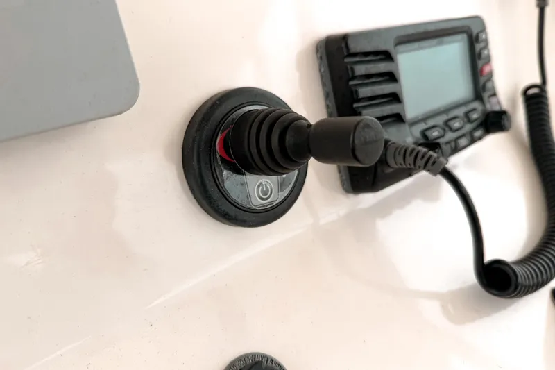 Slide: The Image of Control panel of a 2014 Pursuit S 280 Sport boat with joystick and radio. - 15