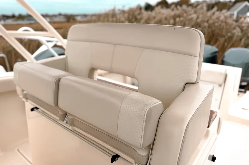 Slide: The Image of 2014 Pursuit S 280 Sport boat seat with beige upholstery, showcasing comfort and style. - 16