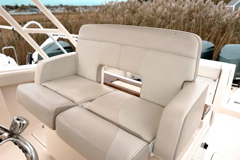 Slide: The Image of 2014 Pursuit S 280 Sport boat seat with beige upholstery and sturdy design. - 17