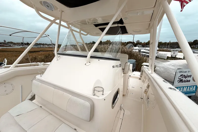 Slide: The Image of 2014 Pursuit S 280 Sport boat interior at Striper Marina, featuring seating and helm. - 19