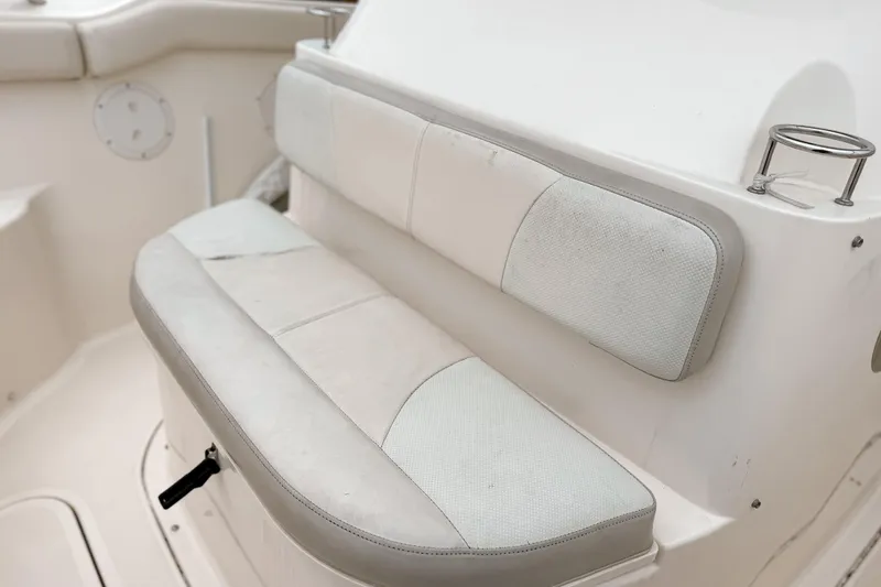 Slide: The Image of 2014 Pursuit S 280 Sport boat seating with cup holder and white upholstery. - 20