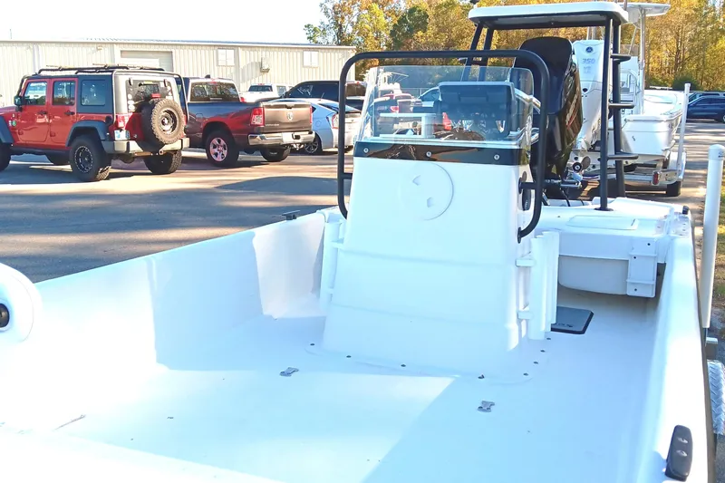 Slide: The Image of 2014 Sundance K16CC boat in parking lot with vehicles in background. - 10