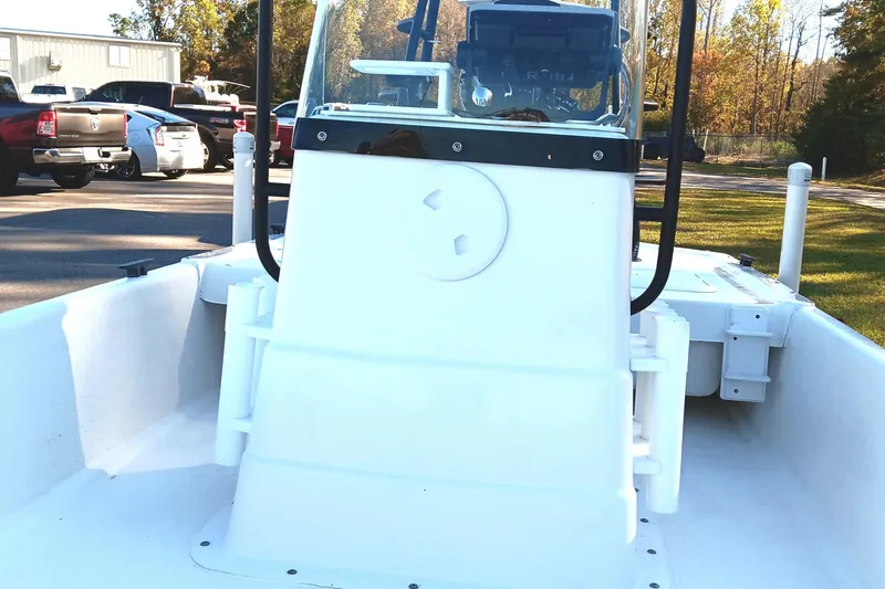 Slide: The Image of 2014 Sundance K16CC boat in parking lot with cars and trees in background. - 8