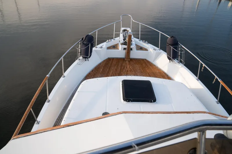 Slide: The Image of 1991 Marine Trader 46 fast trawler, wooden deck, calm water, elegant design. - 10