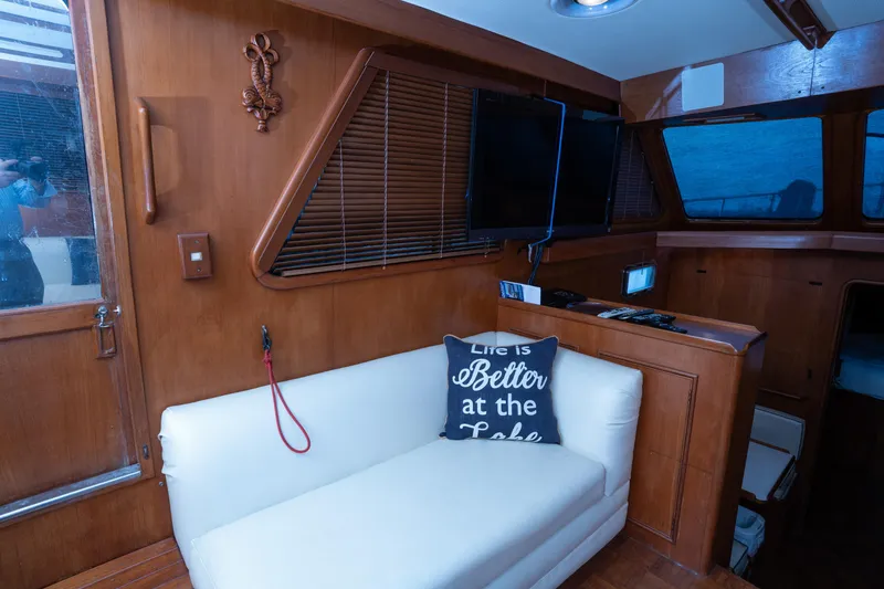 Slide: The Image of Interior of 1991 Marine Trader 46 fast trawler with cozy seating and decorative pillow. - 18