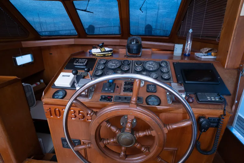 Slide: The Image of 1991 Marine Trader 46 fast trawler helm with wooden wheel and navigation instruments. - 20