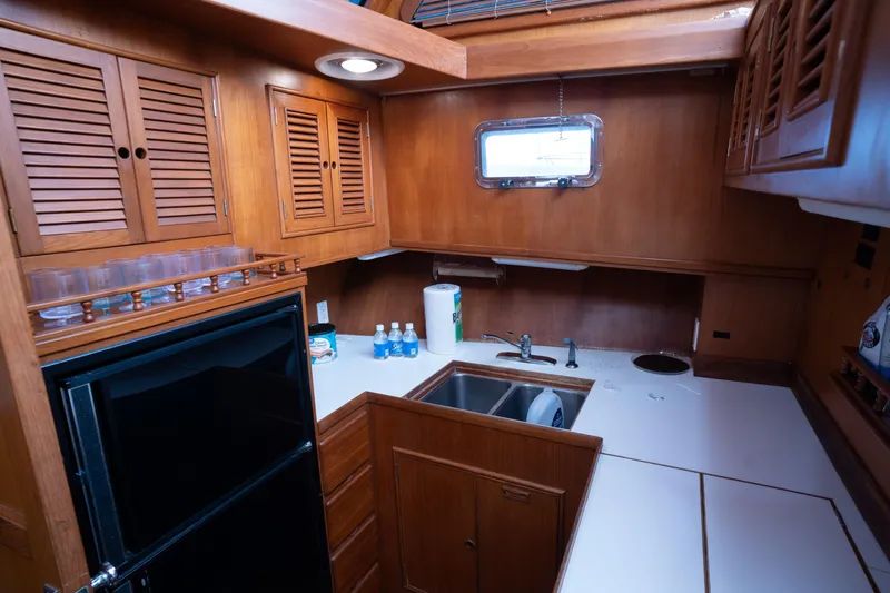 Slide: The Image of Cozy kitchen in 1991 Marine Trader 46 fast trawler with wooden cabinets and compact appliances. - 22