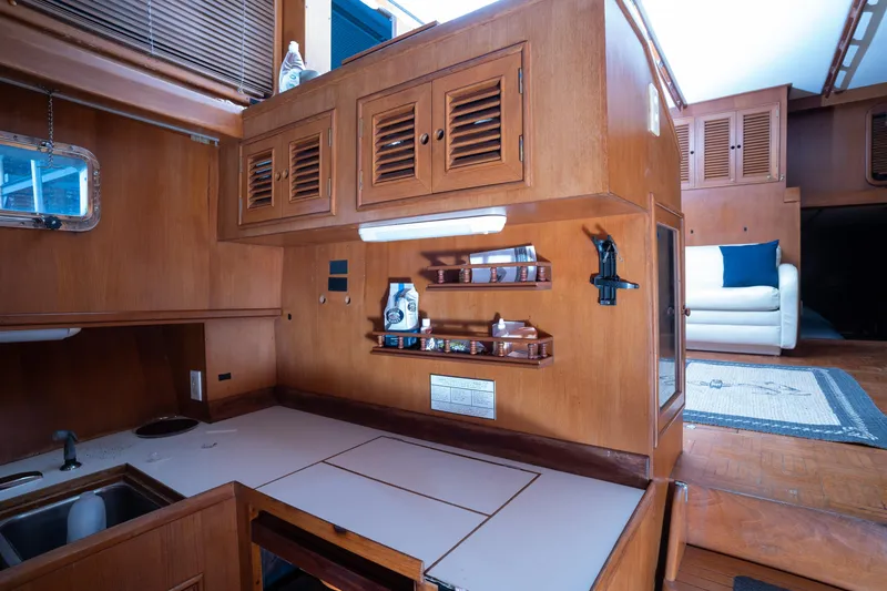 Slide: The Image of Interior of 1991 Marine Trader 46 fast trawler with wooden cabinetry and cozy seating area. - 23