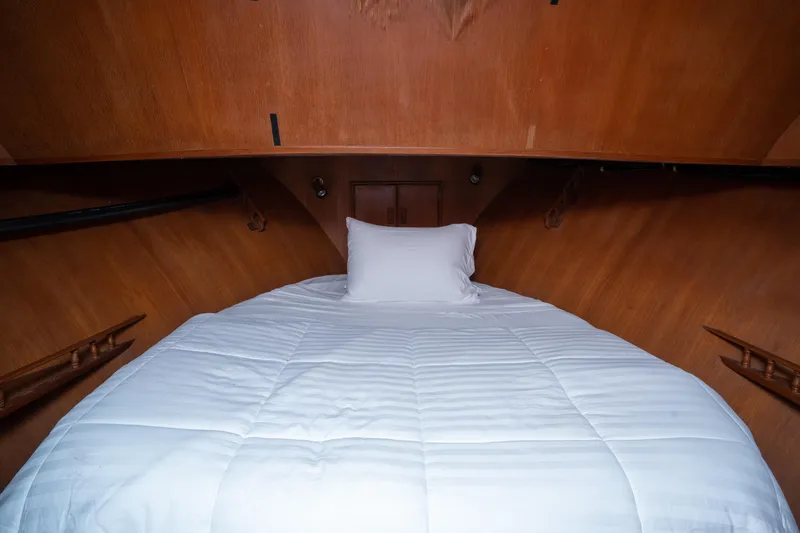 Slide: The Image of Cozy cabin bed in 1991 Marine Trader 46 fast trawler with wooden interior. - 27