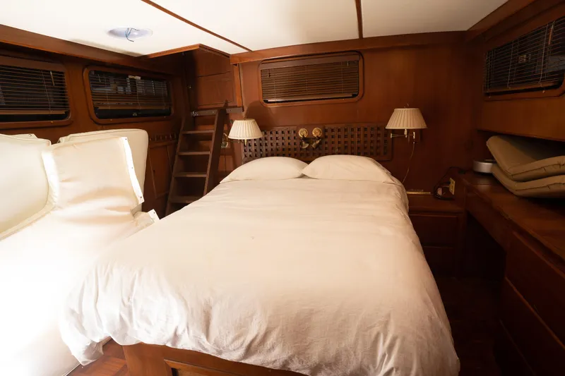 Slide: The Image of Luxurious cabin interior of 1991 Marine Trader 46 fast trawler with cozy bed and wooden decor. - 29
