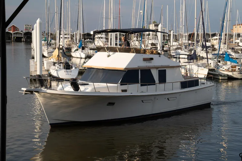 Slide: The Image of 1991 Marine Trader 46 fast trawler in marina, surrounded by sailboats. - 3