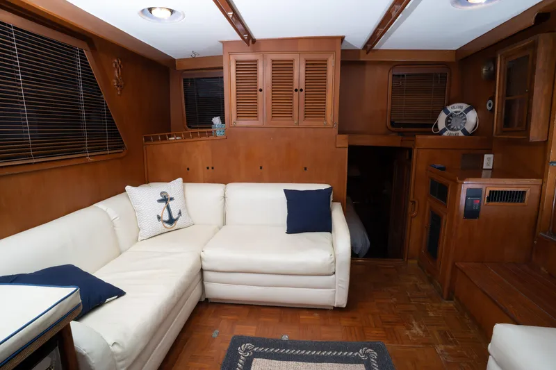Slide: The Image of Interior of 1991 Marine Trader 46 fast trawler with white sofa and nautical decor. - 31
