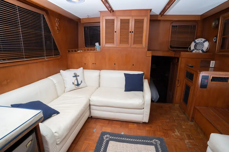 Slide: The Image of 1991 Marine Trader 46 fast trawler interior with white sofa and nautical decor. - 32