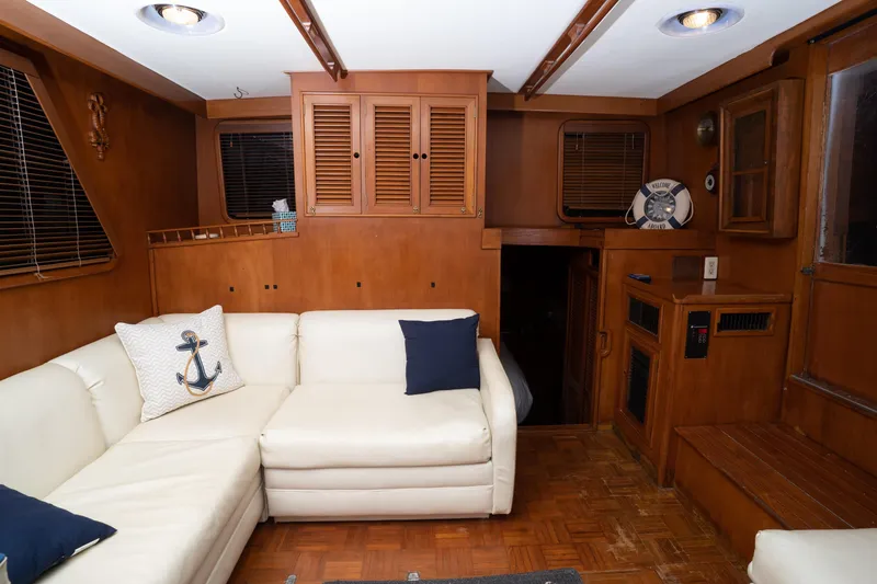 Slide: The Image of Interior of 1991 Marine Trader 46 fast trawler with white sofa and wooden cabinetry. - 33