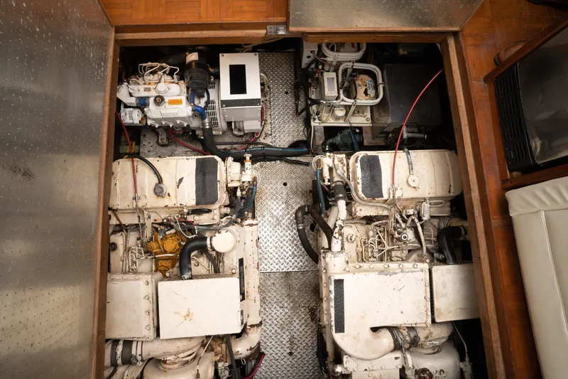 Slide: The Image of Engine room of a 1991 Marine Trader 46 fast trawler, showcasing dual engines and machinery. - 35