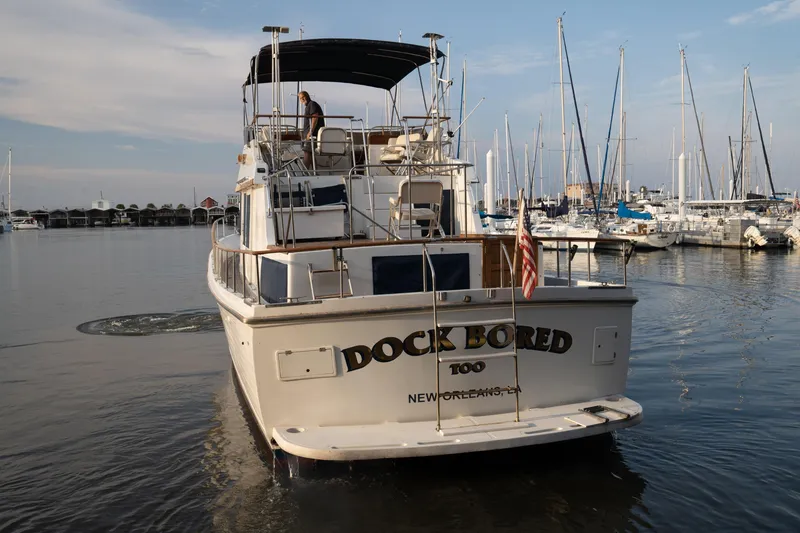Slide: The Image of 1991 Marine Trader 46 fast trawler named "Dock Bored" in a marina setting. - 5