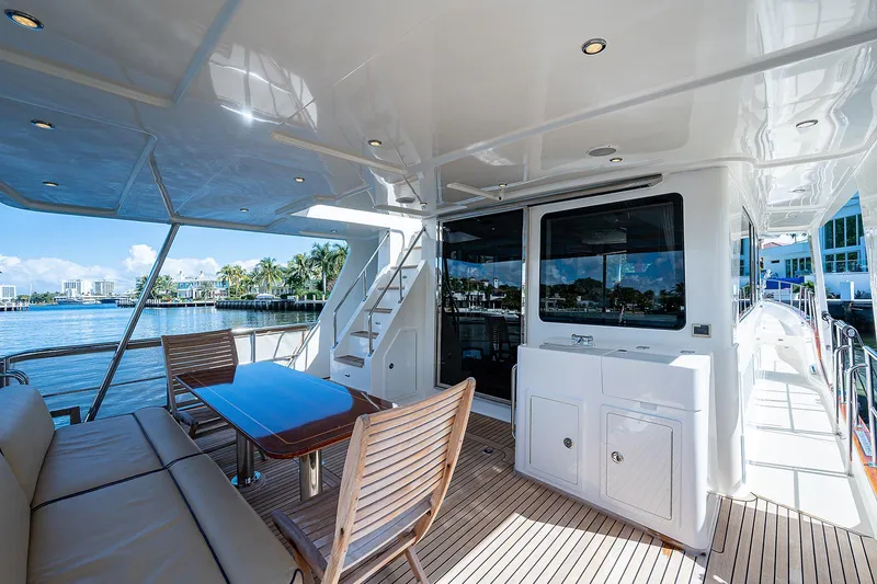Slide: The Image of Luxurious 2013 Grand Banks 54 Europa yacht deck with seating and scenic waterfront view. - 14