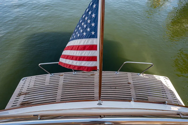 Slide: The Image of Grand Banks 54 Europa 2013 yacht stern with American flag over water. - 16