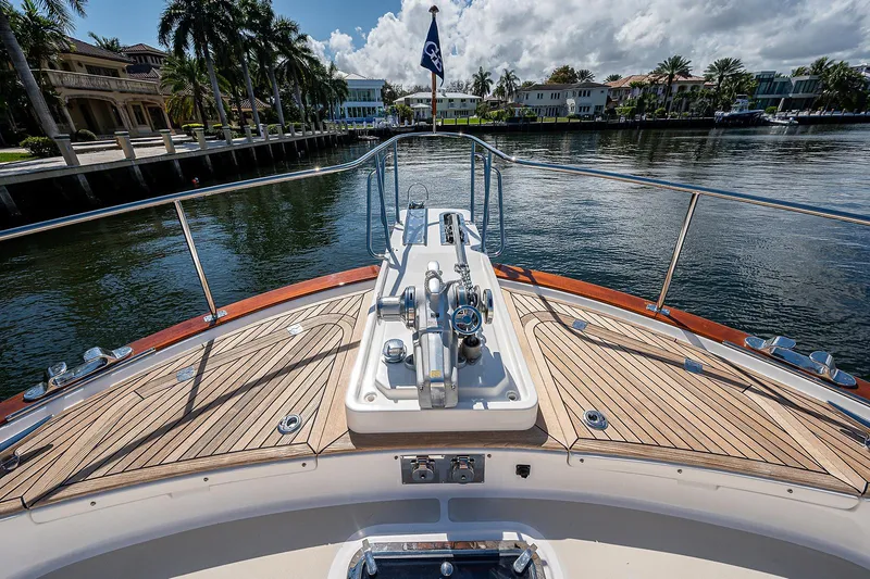 Slide: The Image of Bow view of 2013 Grand Banks 54 Europa yacht, featuring teak decking and waterfront scenery. - 21