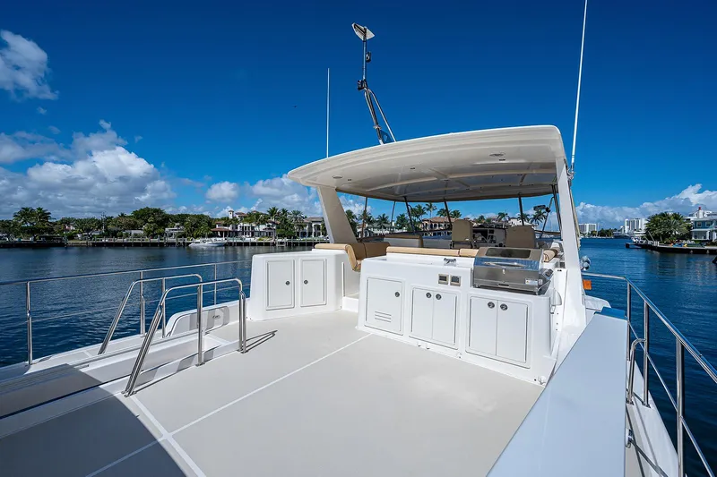 Slide: The Image of 2013 Grand Banks 54 Europa yacht with spacious deck and scenic waterfront view. - 25