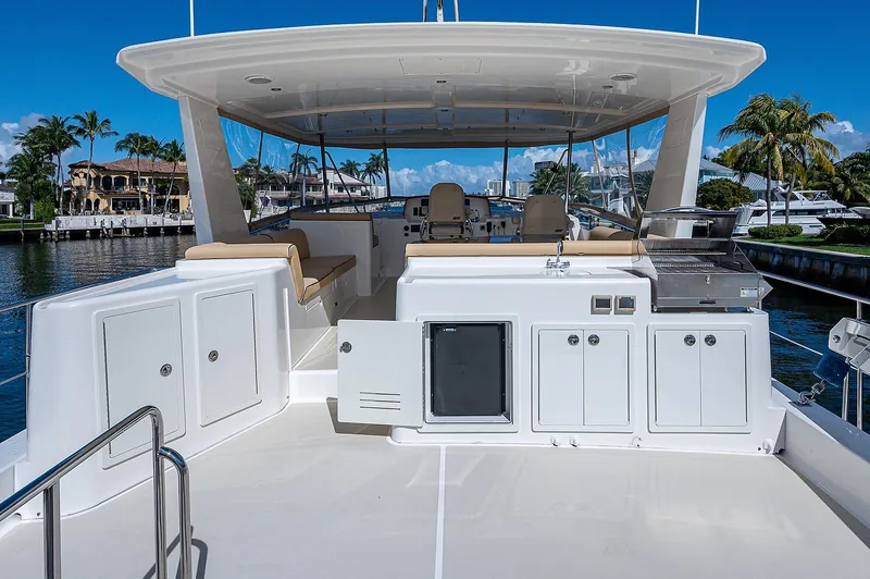 Slide: The Image of Flybridge of 2013 Grand Banks 54 Europa yacht with seating and cabinetry, docked in a marina. - 26