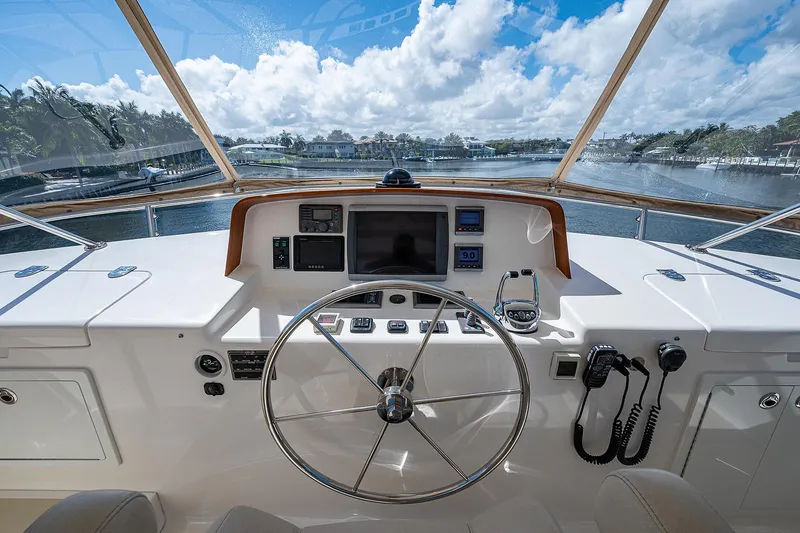 Slide: The Image of Helm of 2013 Grand Banks 54 Europa yacht with navigation equipment and scenic waterway view. - 32