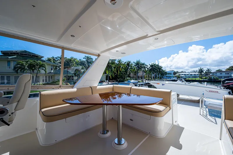 Slide: The Image of Luxurious 2013 Grand Banks 54 Europa yacht with elegant outdoor seating and scenic marina view. - 35