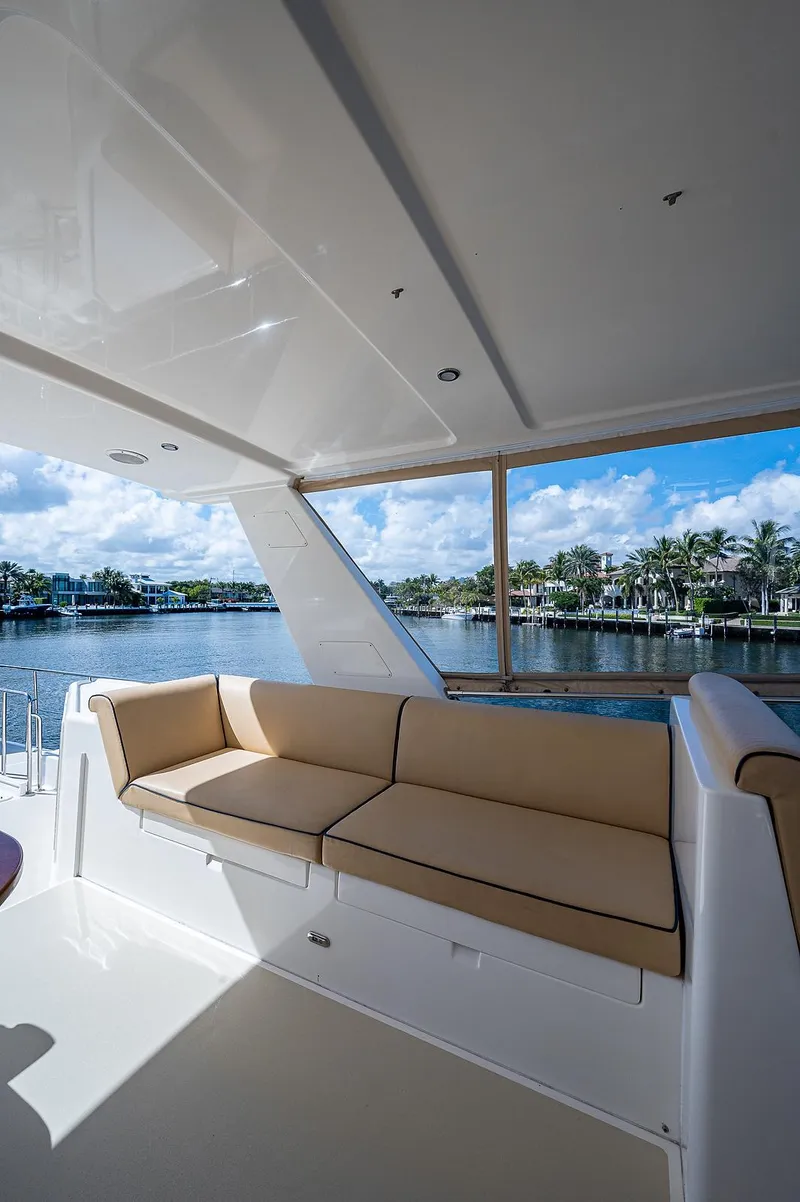 Slide: The Image of 2013 Grand Banks 54 Europa yacht with beige seating, overlooking serene waterfront views. - 36