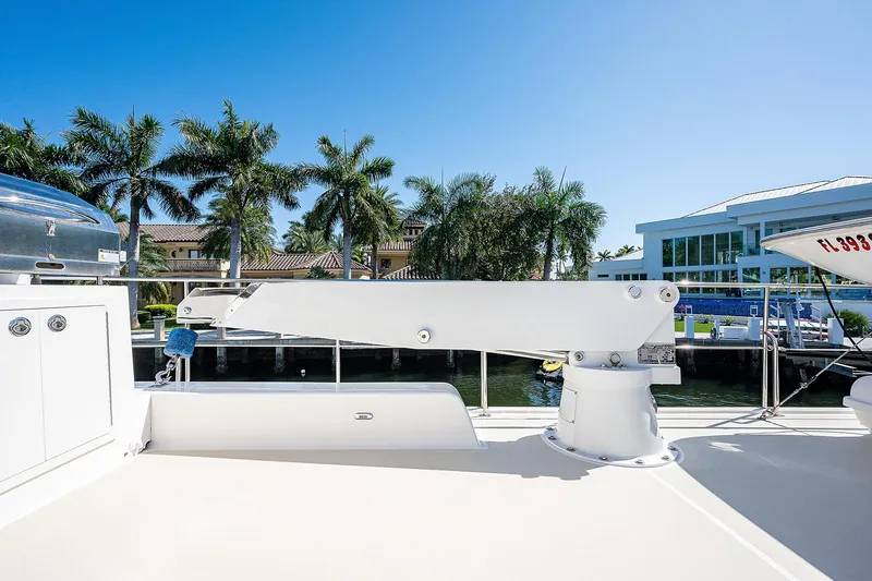 Slide: The Image of 2013 Grand Banks 54 Europa yacht deck with crane, palm trees, and waterfront view. - 44