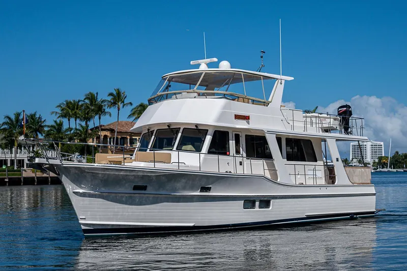 Slide: The Image of 2013 Grand Banks 54 Europa yacht on calm water, with clear blue sky background. - 5