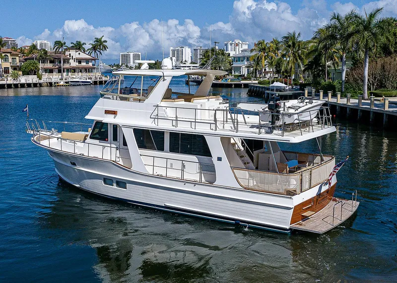 Slide: The Image of 2013 Grand Banks 54 Europa yacht cruising in a scenic waterfront setting. - 6