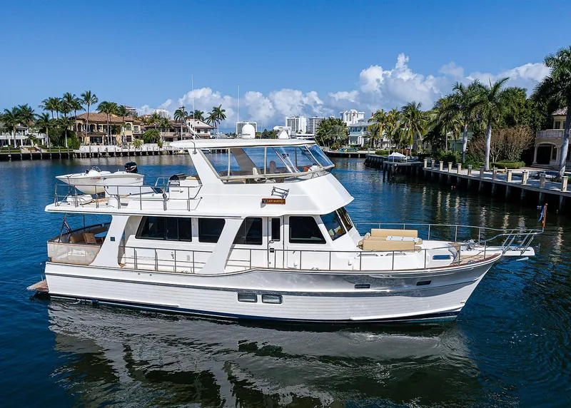 Slide: The Image of 2013 Grand Banks 54 Europa yacht cruising in a scenic waterfront setting. - 7