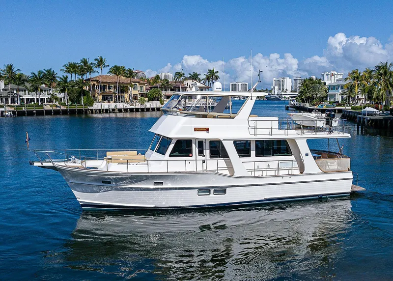 Slide: The Image of 2013 Grand Banks 54 Europa yacht cruising in a scenic waterfront setting. - 8