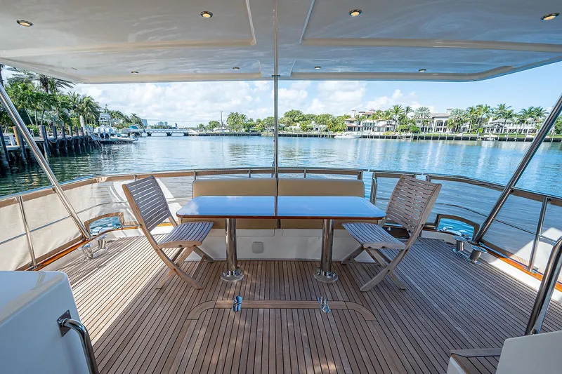 Slide: The Image of Grand Banks 54 Europa 2013 yacht deck with seating, overlooking serene waterfront view. - 9