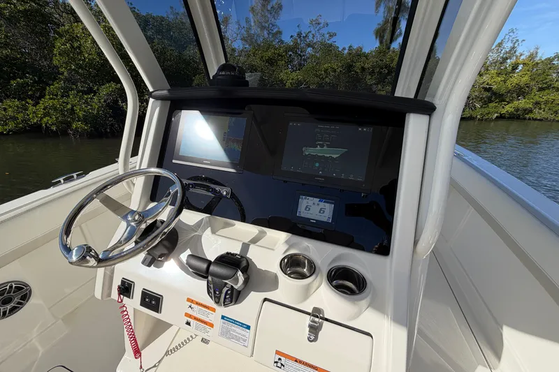 Slide: The Image of Helm of 2026 World Cat 280 CC-X boat with modern controls and navigation display. - 12