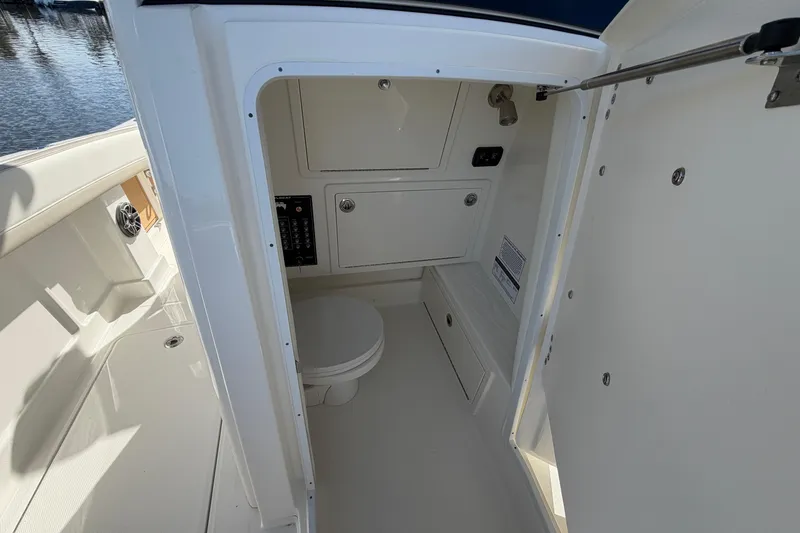 Slide: The Image of Interior view of 2026 World Cat 280 CC-X boat's compact bathroom area. - 15