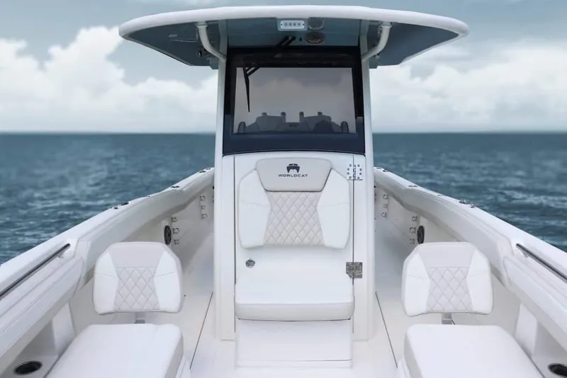 Slide: The Image of 2026 World Cat 280 CC-X boat cruising on calm water near lush greenery. - 5