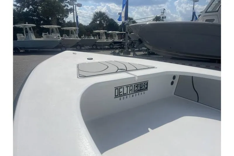 Slide: The Image of 2026 Delta Boatworks D18 boat displayed outdoors under a sunny sky. - 4